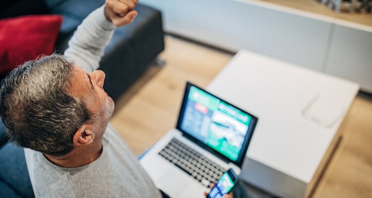 Imagen de un apostador levantando el puño. Los Mejores Sitios De Apuestas De Fútbol.